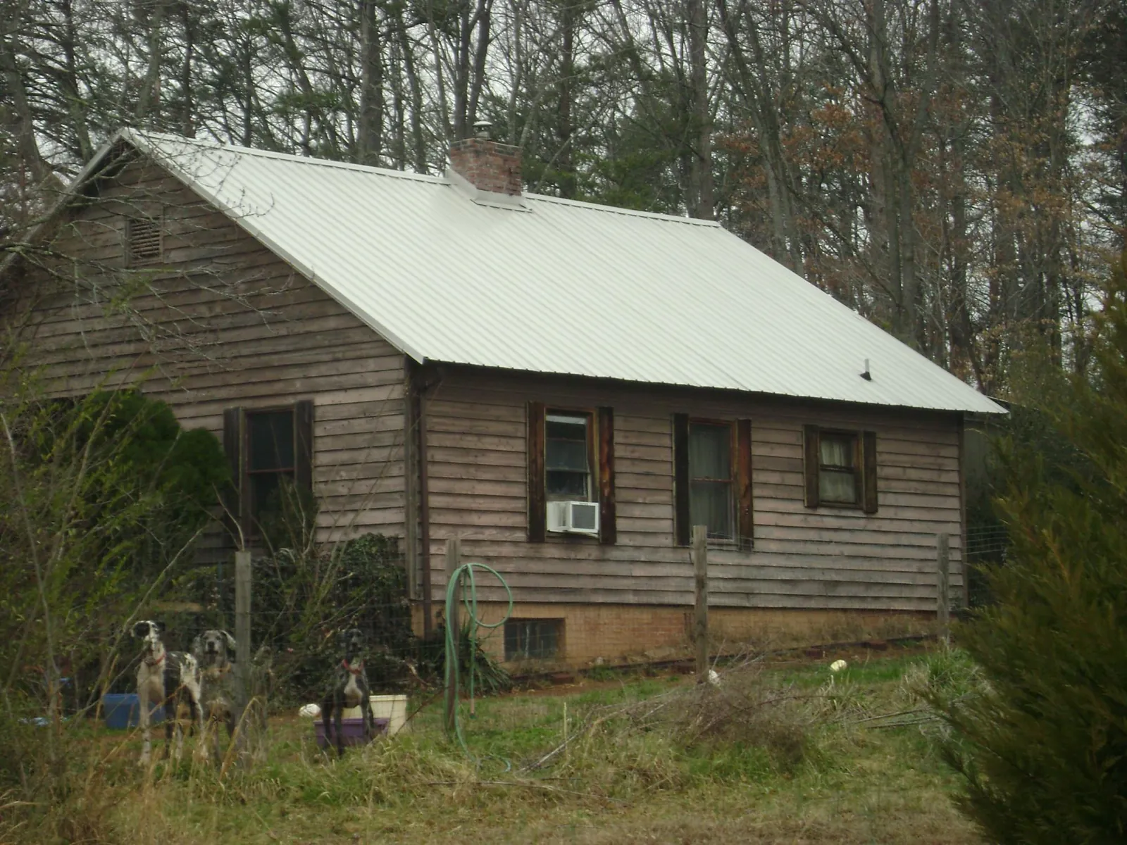 White metal roof on an old wood sided farmhouse, from a Metal Roof Installation job in New Site